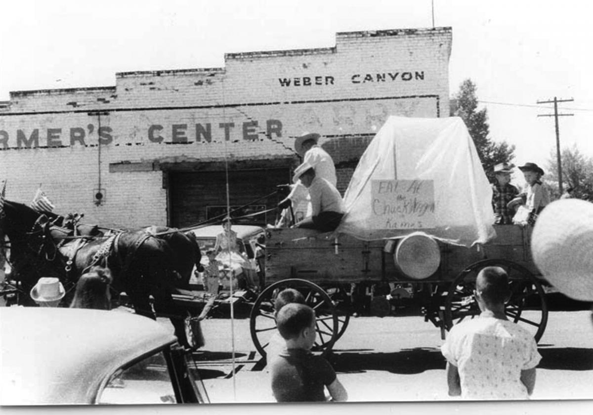 July 4th parade with a store where the post office is now located in the background